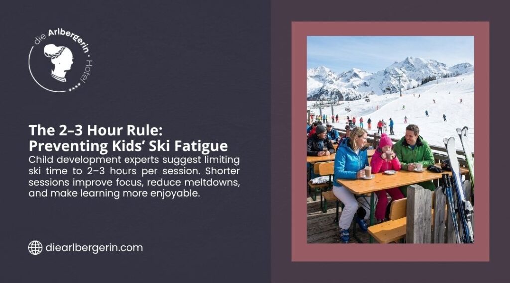 Family with two children in ski gear sitting at an outdoor wooden table on a sunny ski slope, drinking hot drinks with snow-covered mountains and skiers in the background.