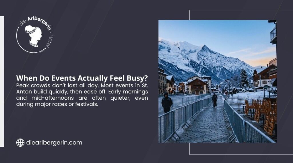 Quiet cobblestone street in a snowy Alpine town with mountains in the background during a St. Anton event period.