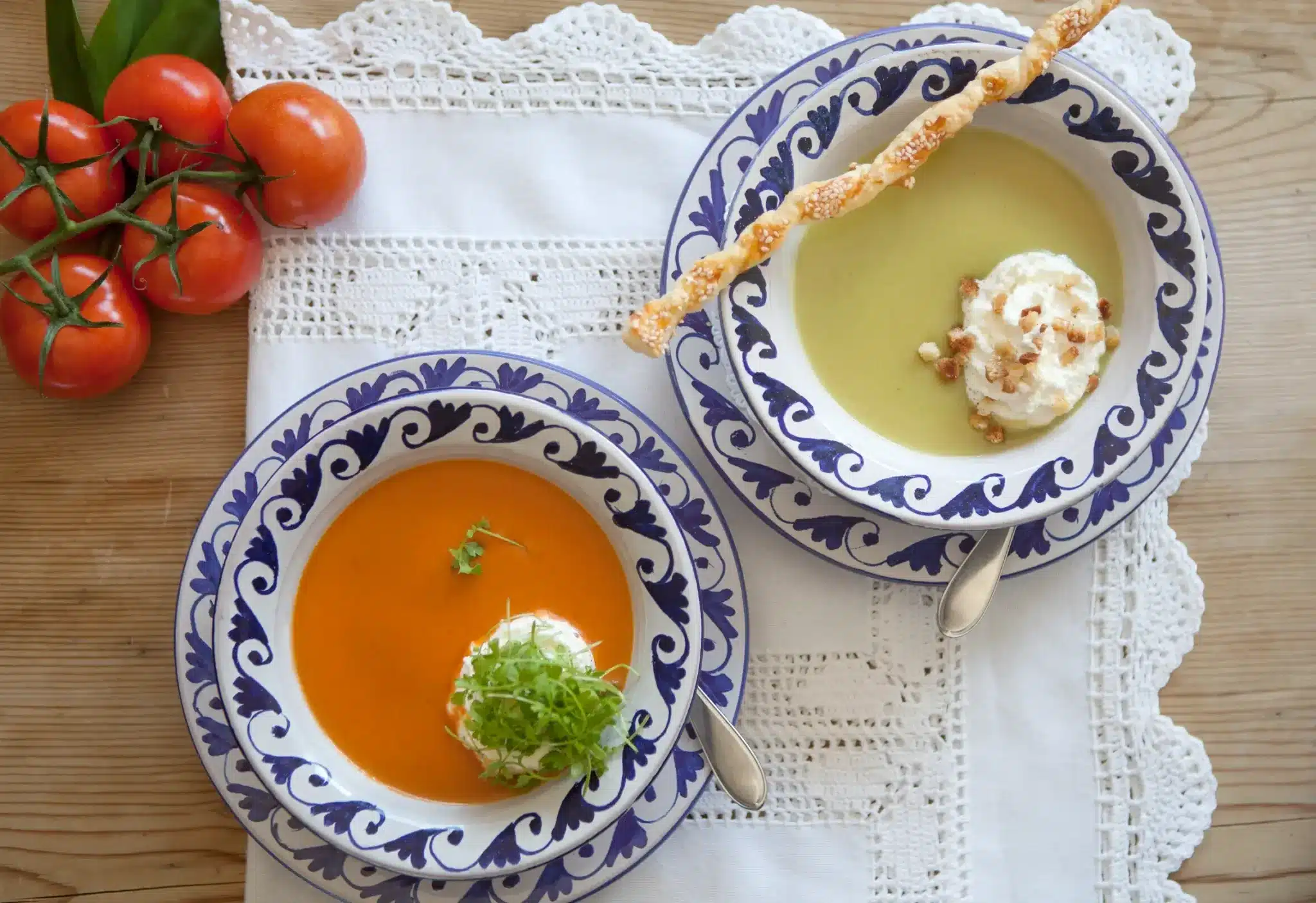 Startseite 70 Two cream soups in patterned bowls with tomatoes and breadsticks